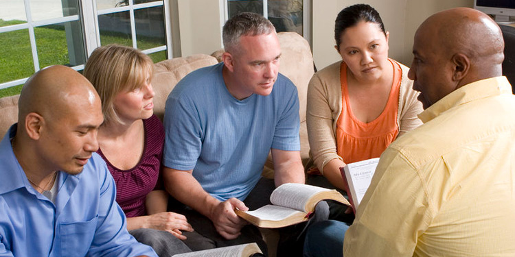 Group of adults studying the Bible together